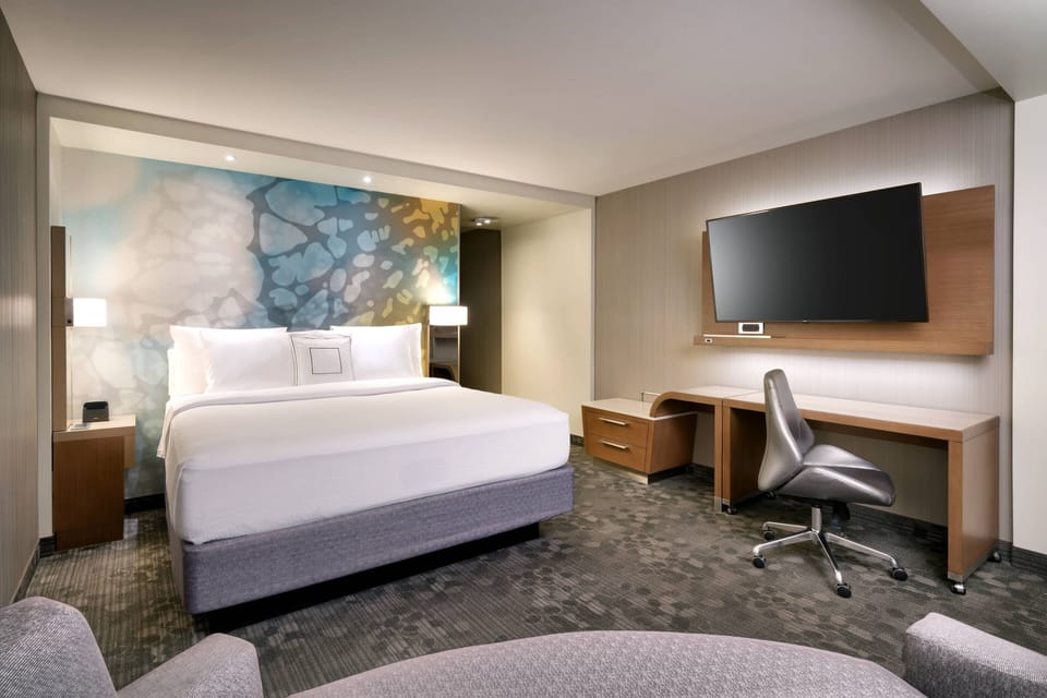 Premium bedding, desk, laptop workspace, iron/ironing board