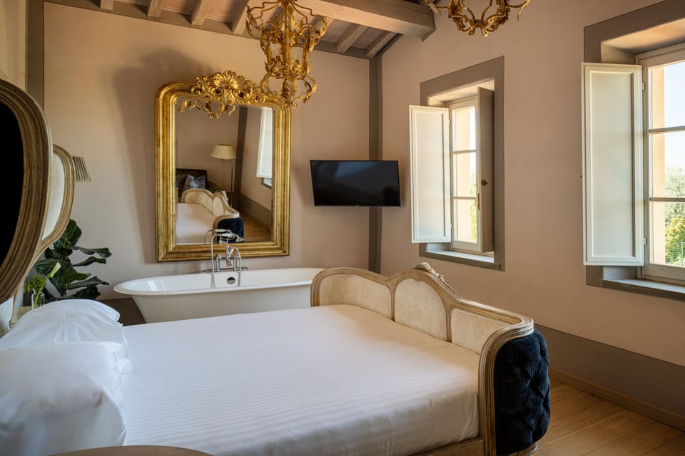 Deluxe Room, 1 Bedroom, Garden View | Minibar, in-room safe, desk, iron/ironing board