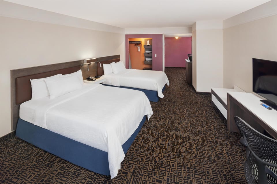 Premium bedding, in-room safe, laptop workspace, soundproofing