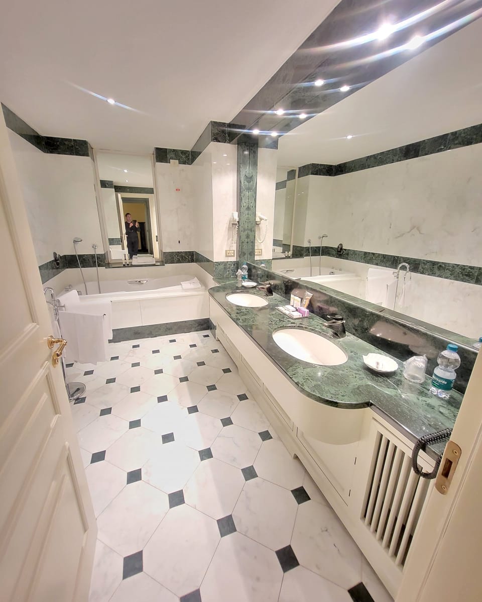 Deluxe Suite, Jetted Tub | Bathroom | Combined shower/tub, deep soaking tub, rainfall showerhead