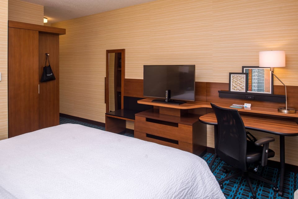 Premium bedding, desk, laptop workspace, blackout drapes