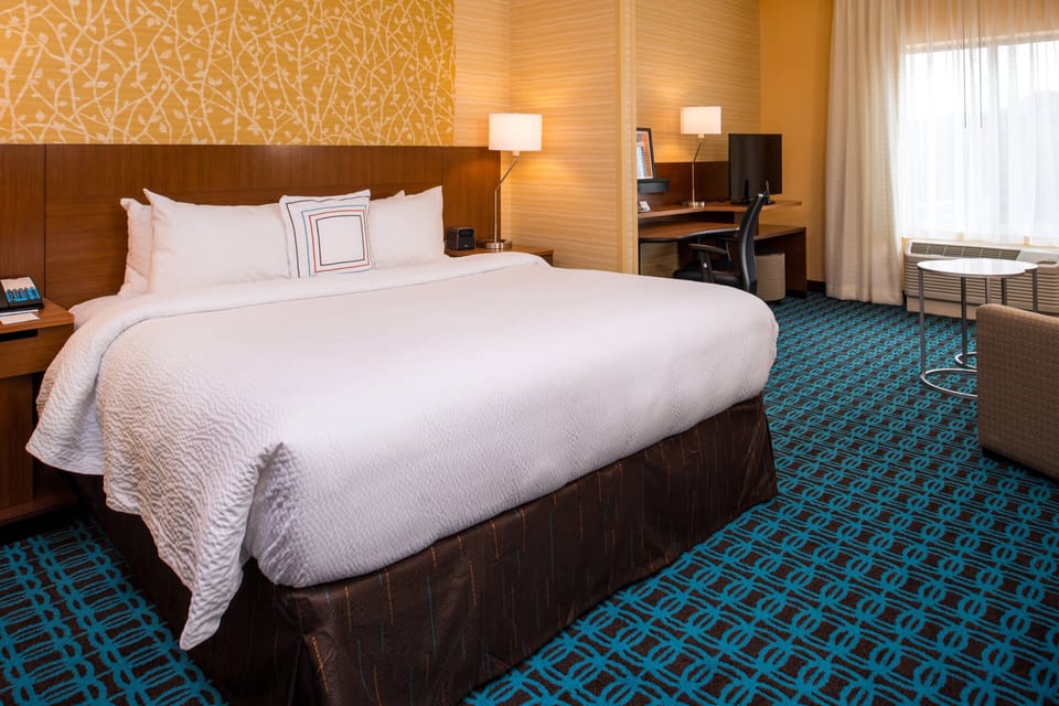Premium bedding, desk, laptop workspace, blackout drapes