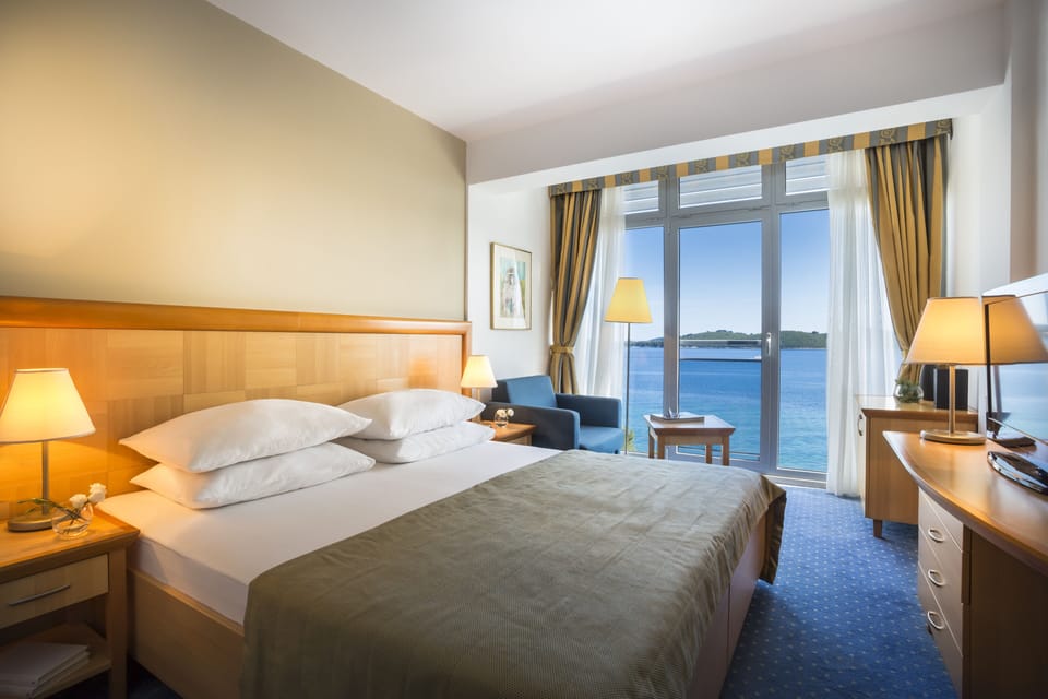 Superior Double Room, Sea View | Minibar, in-room safe, desk, blackout drapes