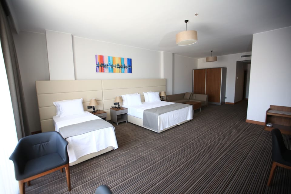 Standard Triple Room | Minibar, in-room safe, desk, iron/ironing board