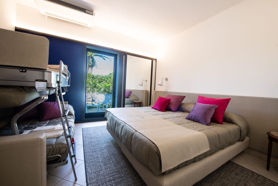 Superior Quadruple Room | Minibar, in-room safe, desk, laptop workspace