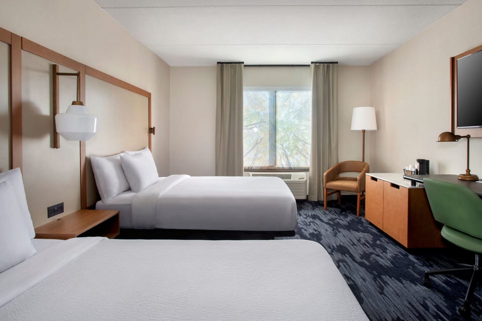 Premium bedding, desk, laptop workspace, blackout drapes