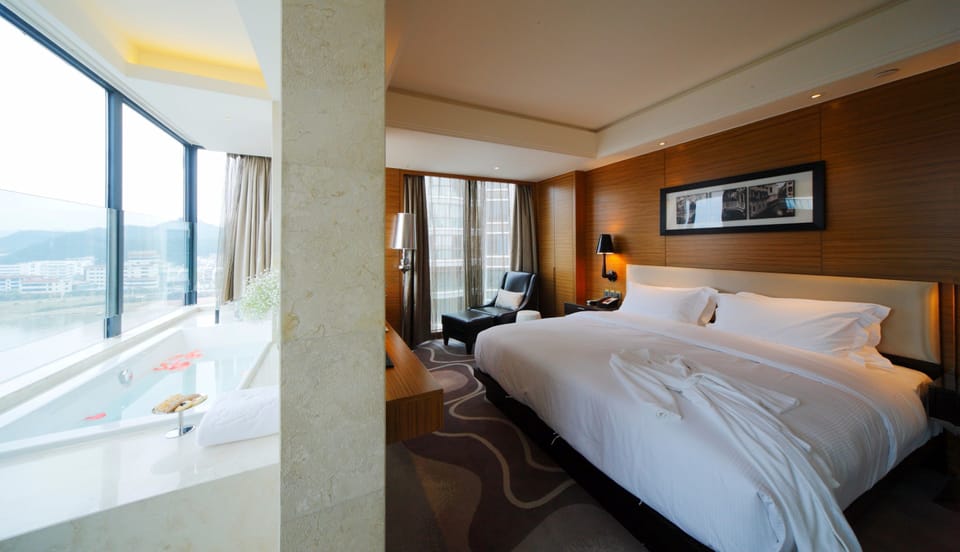 Deluxe Double Room, River View | Minibar, in-room safe, desk, laptop workspace