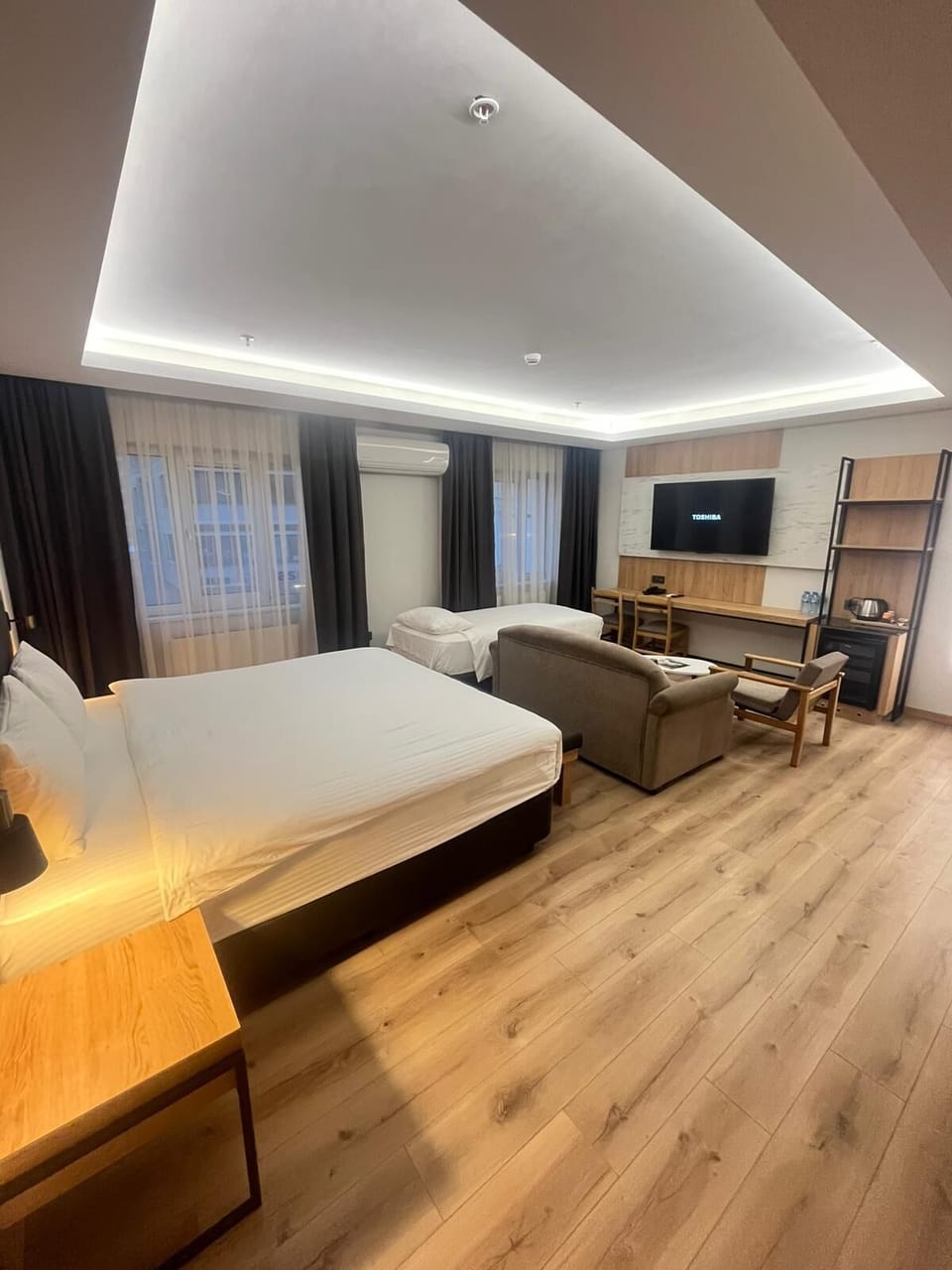 Comfort Quadruple Room | Living area | 45-inch LCD TV with satellite channels, TV