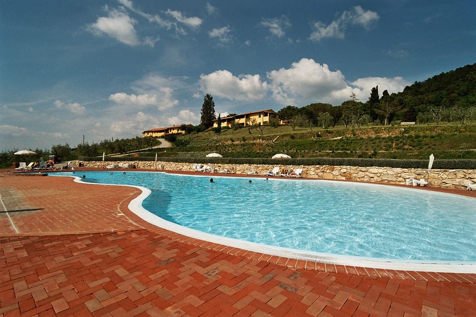 Seasonal outdoor pool, open 9:00 AM to 8:00 PM, pool umbrellas