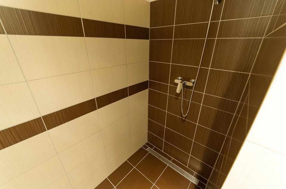 Quadruple Room | Bathroom | Shower, hair dryer, towels
