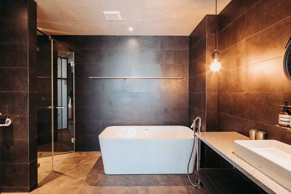 U.I.J Suite | Bathroom | Hair dryer, slippers, towels