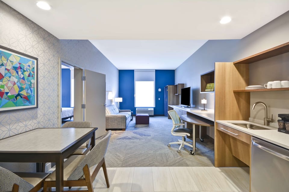 Hypo-allergenic bedding, desk, laptop workspace, blackout drapes