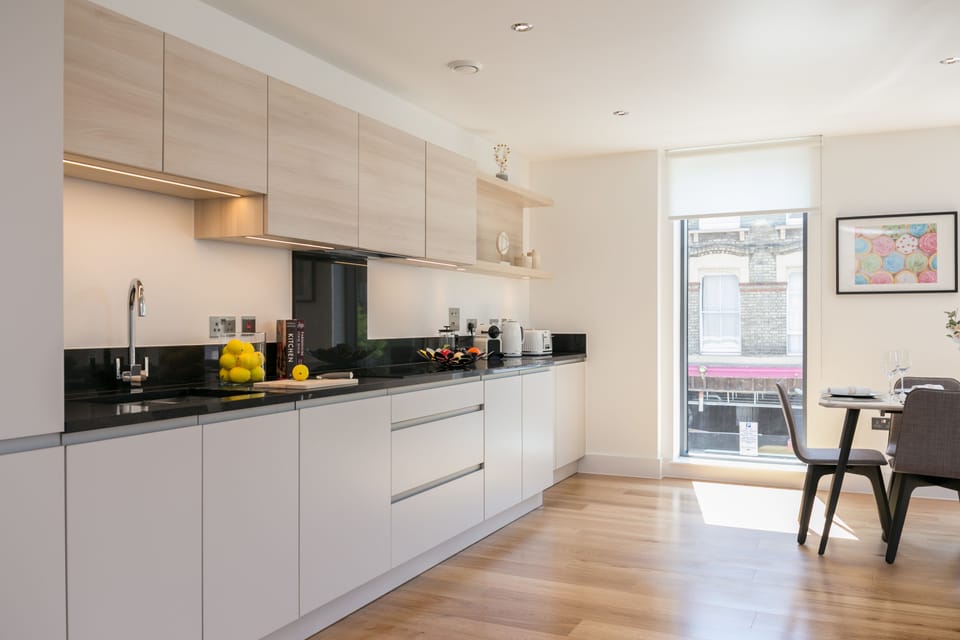 Deluxe Two Bedroom Apartment with Balcony | Private kitchen | Coffee/tea maker, full-size fridge, microwave, oven