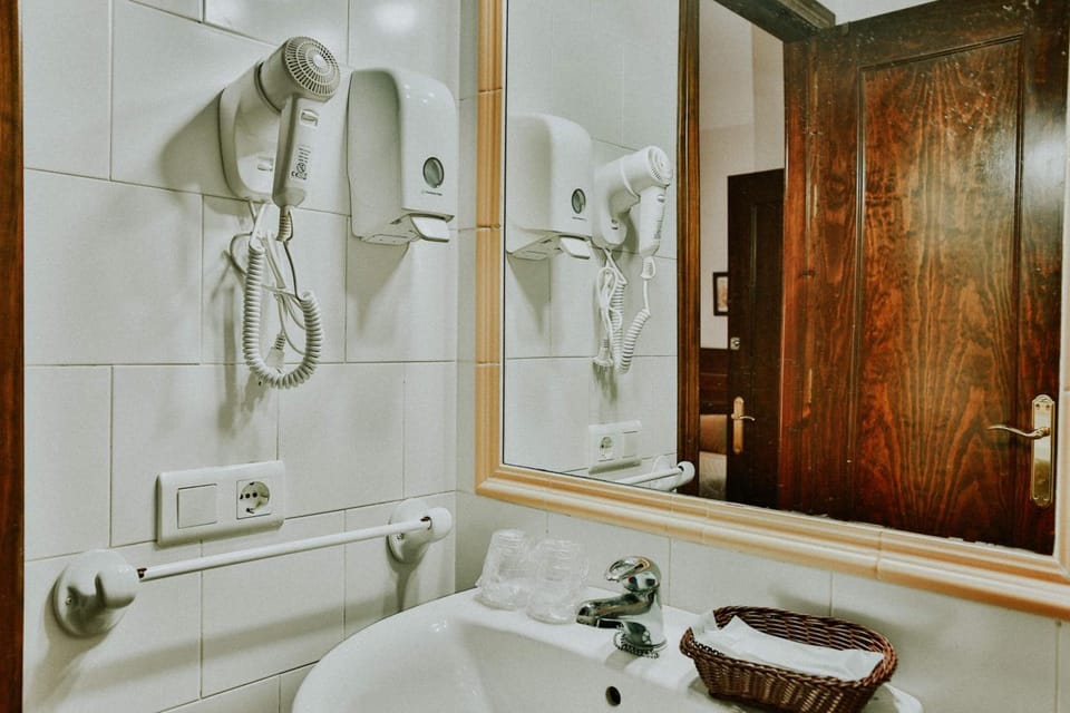 Shower, designer toiletries, hair dryer, towels