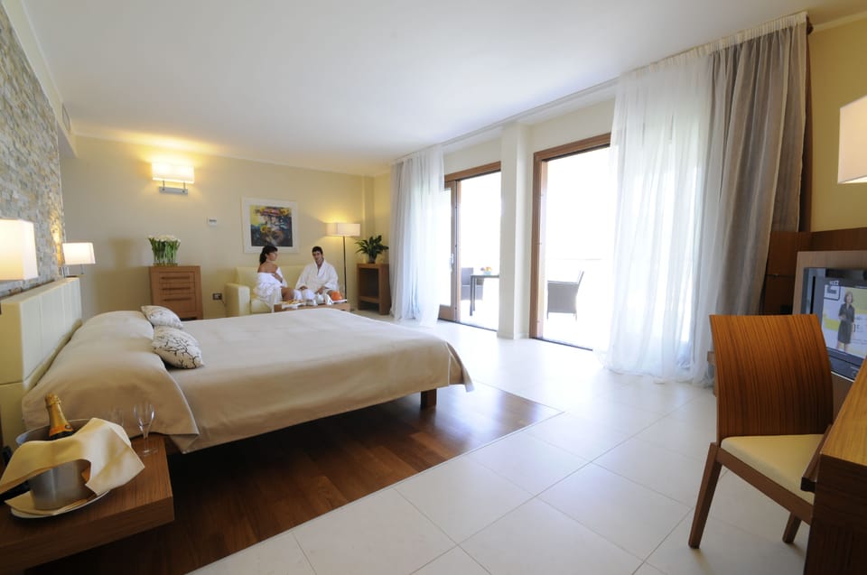 Luxury Suite, Hot Tub, Sea Facing | Minibar, in-room safe, desk, bed sheets