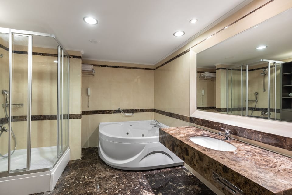 Suite, Sea View | Bathroom | Shower, free toiletries, hair dryer, bathrobes
