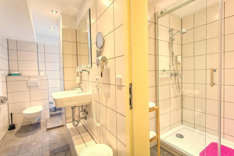 Shower, hair dryer, towels, shampoo