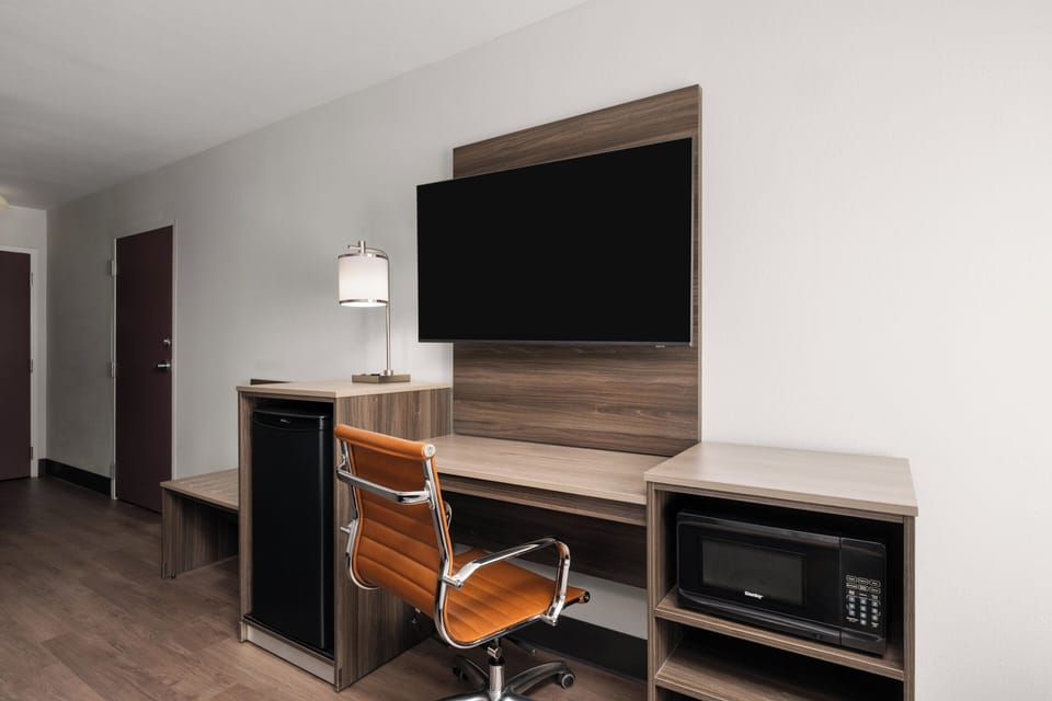 Premium bedding, desk, laptop workspace, blackout drapes