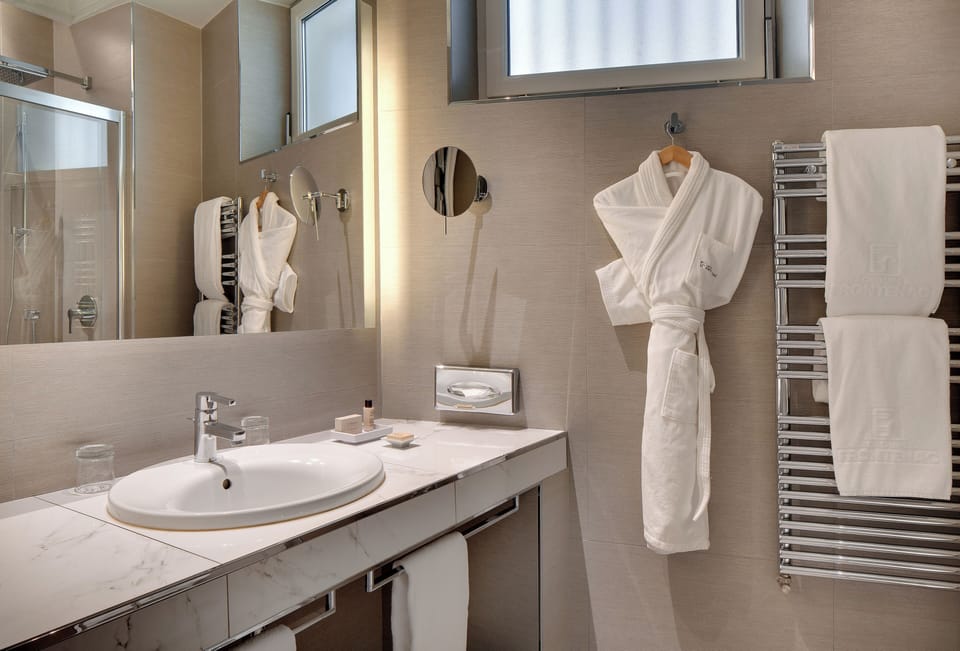 Shower, designer toiletries, hair dryer, bathrobes