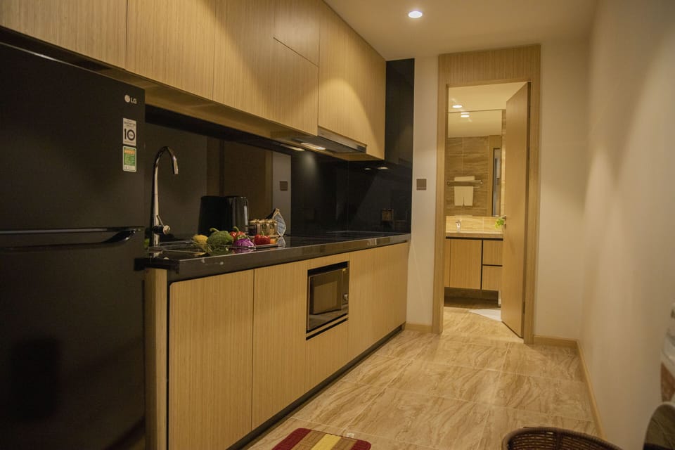 Executive Two-bedroom Apartment | Private kitchen | Fridge, electric kettle, paper towels