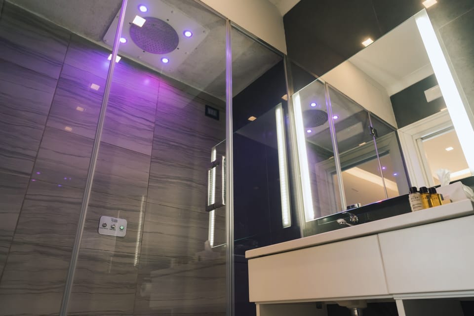 Superior Suite | Bathroom | Rainfall showerhead, designer toiletries, hair dryer, slippers
