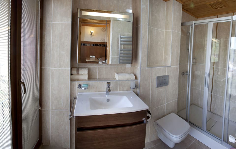 Shower, designer toiletries, hair dryer, bathrobes