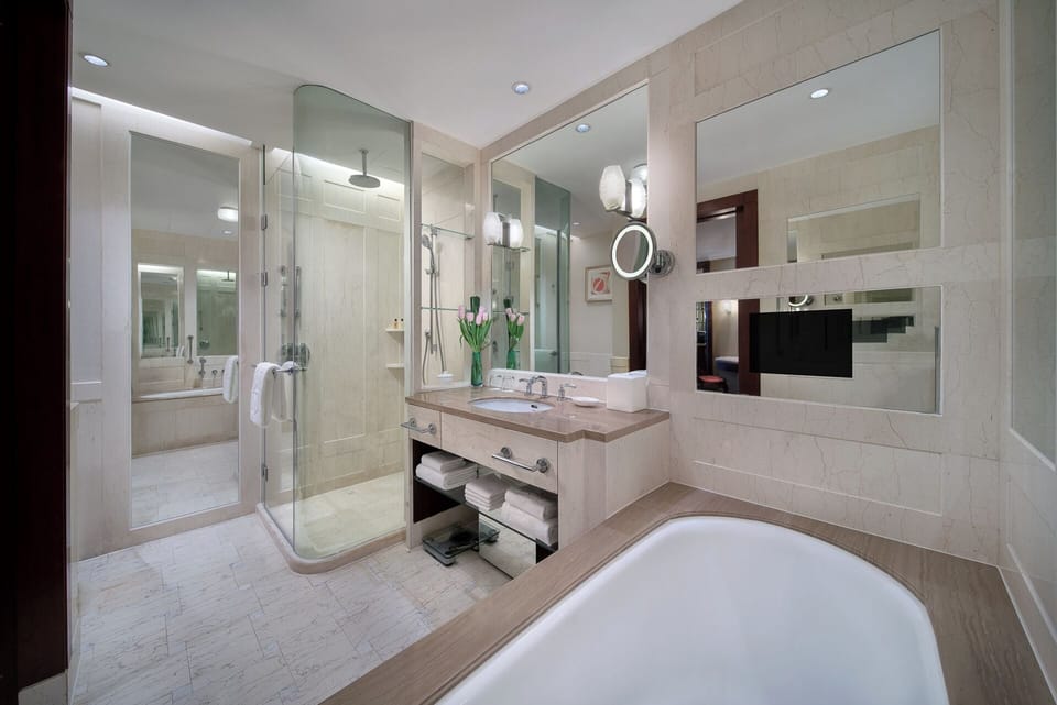 Separate tub and shower, designer toiletries, hair dryer, bathrobes