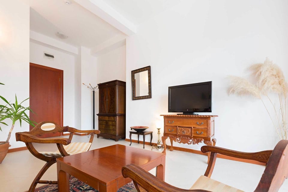 Deluxe Room, Terrace, Courtyard View | Living area | Flat-screen TV