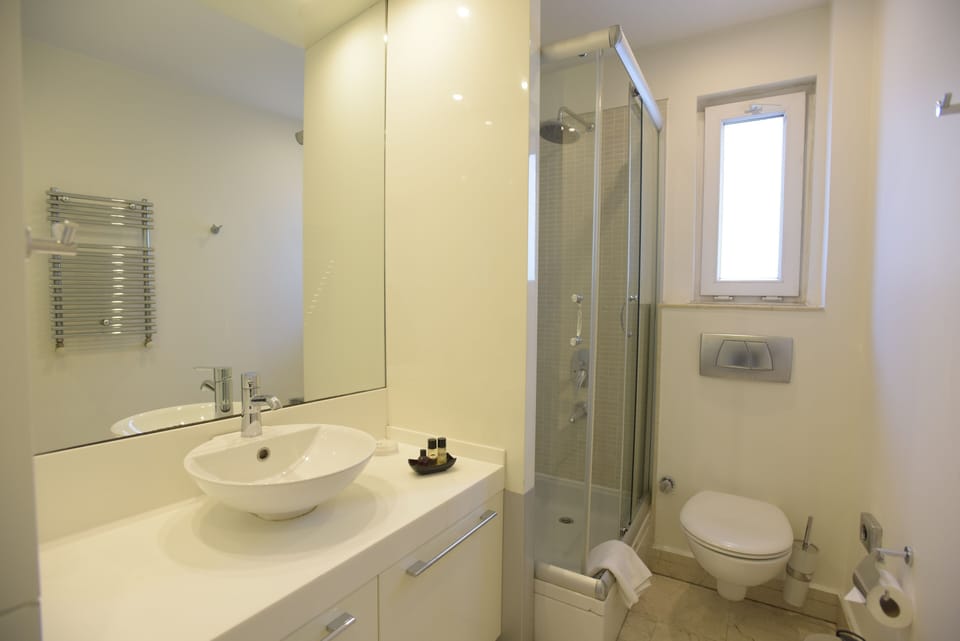 Shower, hair dryer, slippers, towels