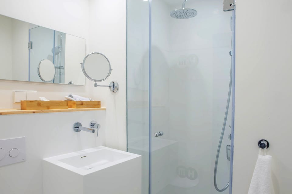 Shower, rainfall showerhead, hair dryer, towels