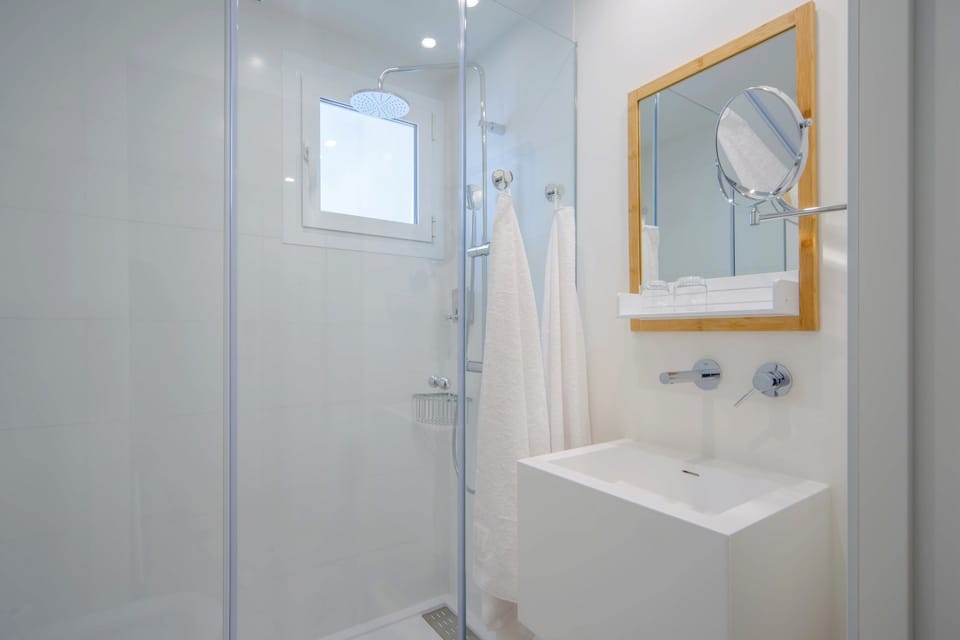 Shower, rainfall showerhead, hair dryer, towels