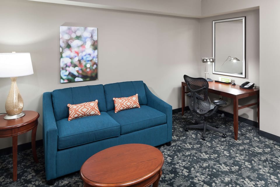 Premium bedding, desk, laptop workspace, blackout drapes