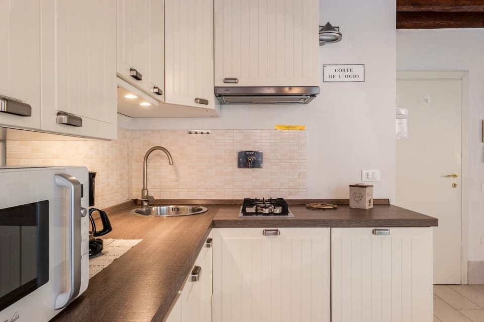 Deluxe Triple Room, Canal View | Private kitchen | Full-size fridge, microwave, stovetop, dishwasher