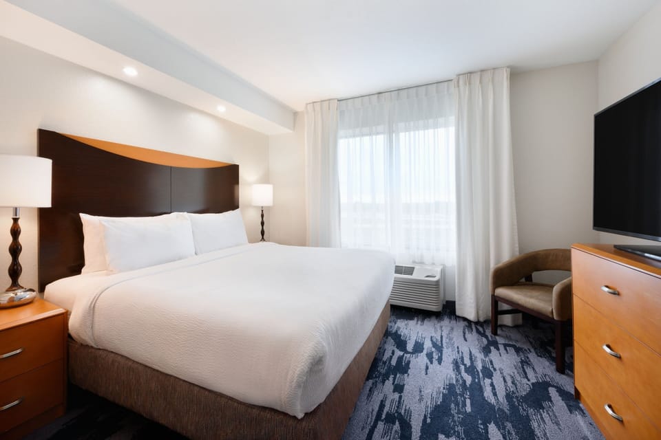 Premium bedding, desk, laptop workspace, iron/ironing board