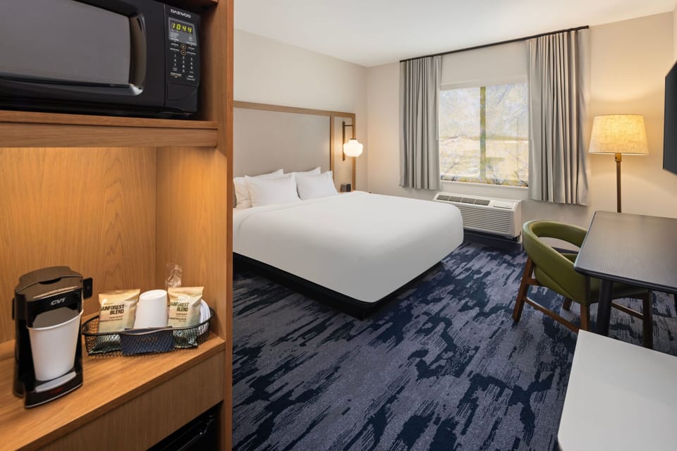 Premium bedding, desk, laptop workspace, blackout drapes