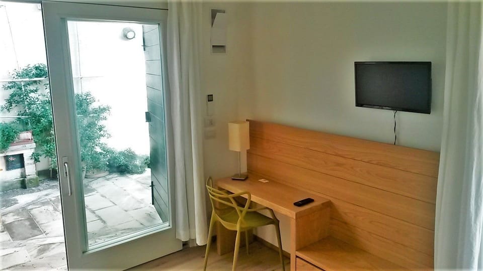 Standard Double Room | Living area | Flat-screen TV