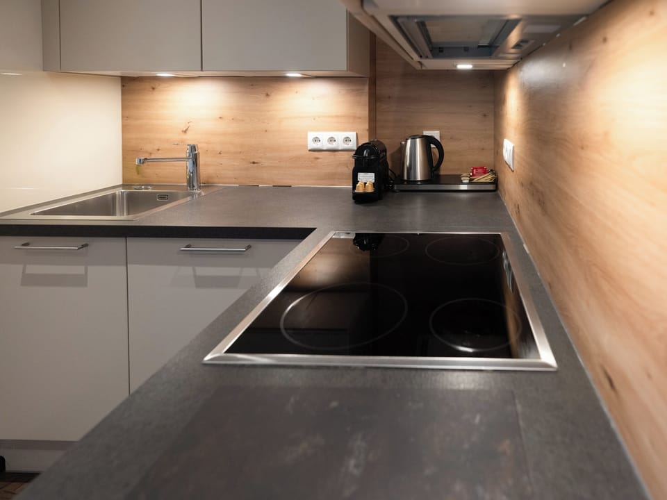 Delux Suite with balcony | Private kitchen | Fridge, highchair, cleaning supplies