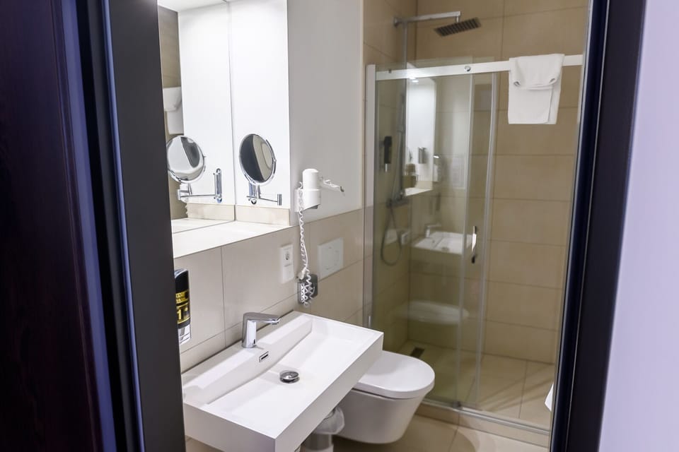 Shower, hair dryer, slippers, towels