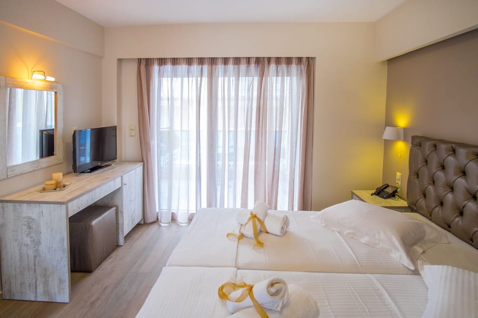 Deluxe Double or Twin Room, Partial Sea View | Minibar, in-room safe, blackout drapes, soundproofing