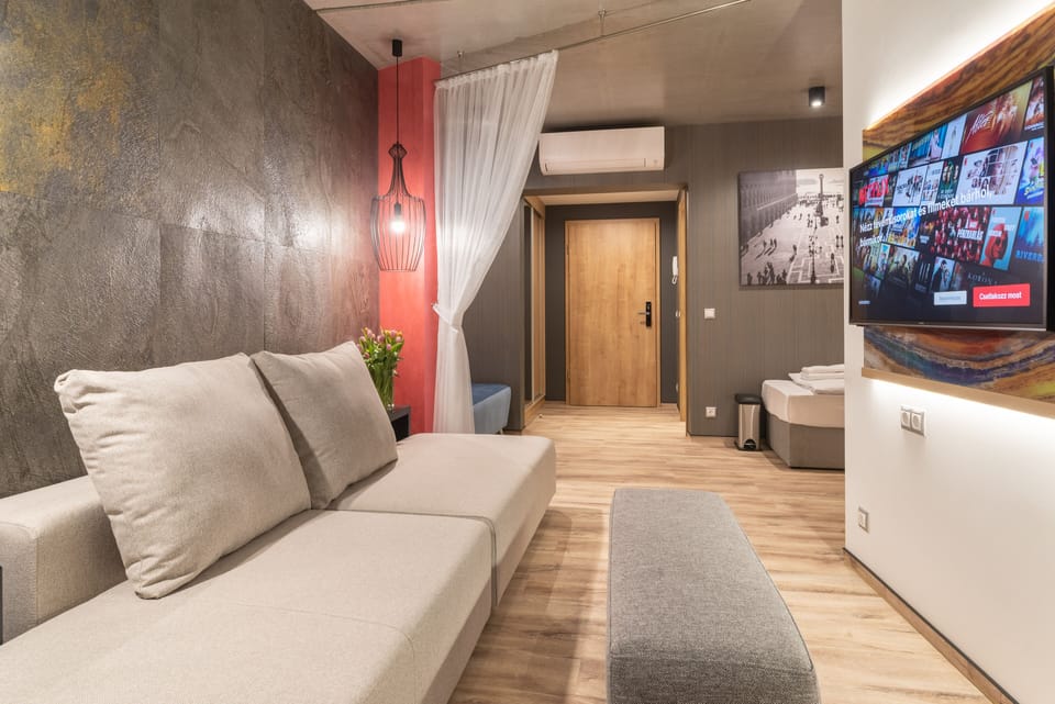 Deluxe family room with balcony on groundfloor | Living area | 75-cm flat-screen TV with satellite channels, TV