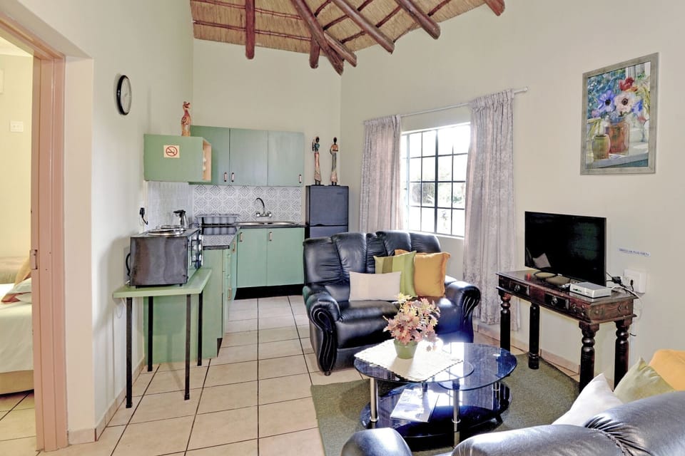 Acacia Cottage | Living area | 30-inch flat-screen TV with satellite channels, TV