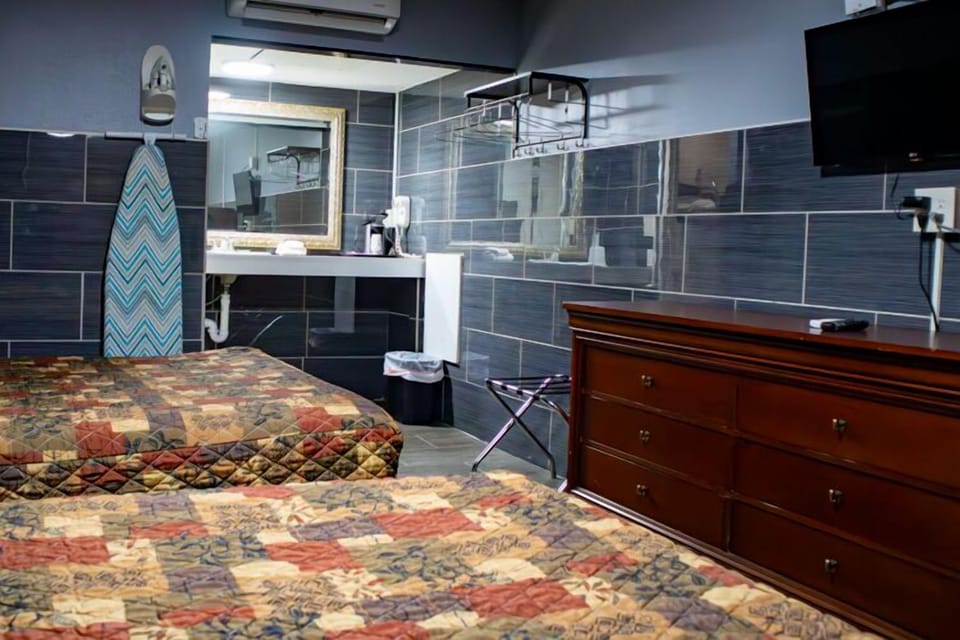 Basic Room, 2 Double Beds | Living area | 32-inch TV with cable channels