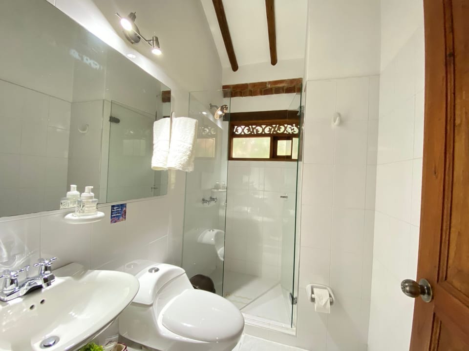 Habitación Triple Estándar, Balcón y Vista al Jardín | Bathroom | Designer toiletries, hair dryer, heated floors, towels