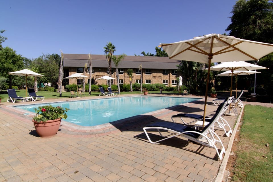 Outdoor pool, pool umbrellas, sun loungers