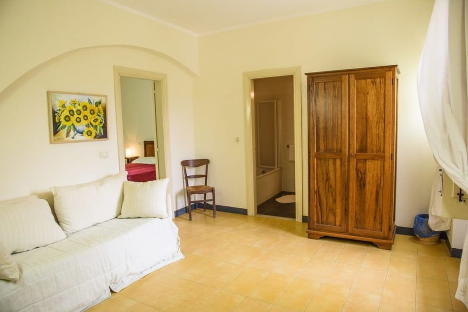Quadruple Room | Living room | Flat-screen TV, books