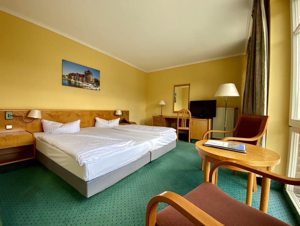 Premium bedding, desk, laptop workspace, blackout drapes