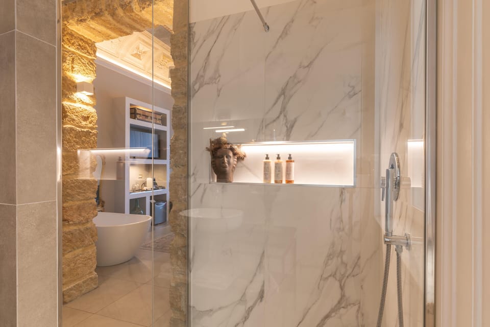 Suite, Balcony, City View | Bathroom | Shower, free toiletries, hair dryer, slippers