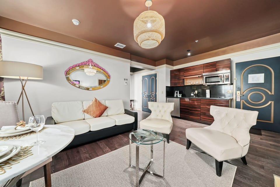 Deluxe One Bedroom Double Queen Suite | Living area | 42-inch plasma TV with cable channels, TV, iPod dock