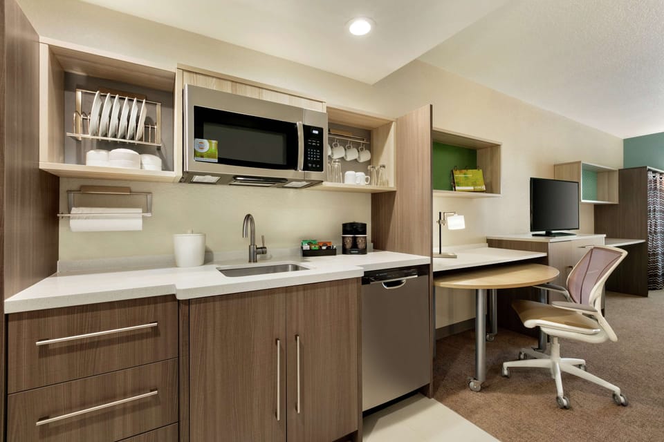 Premium bedding, desk, laptop workspace, blackout drapes