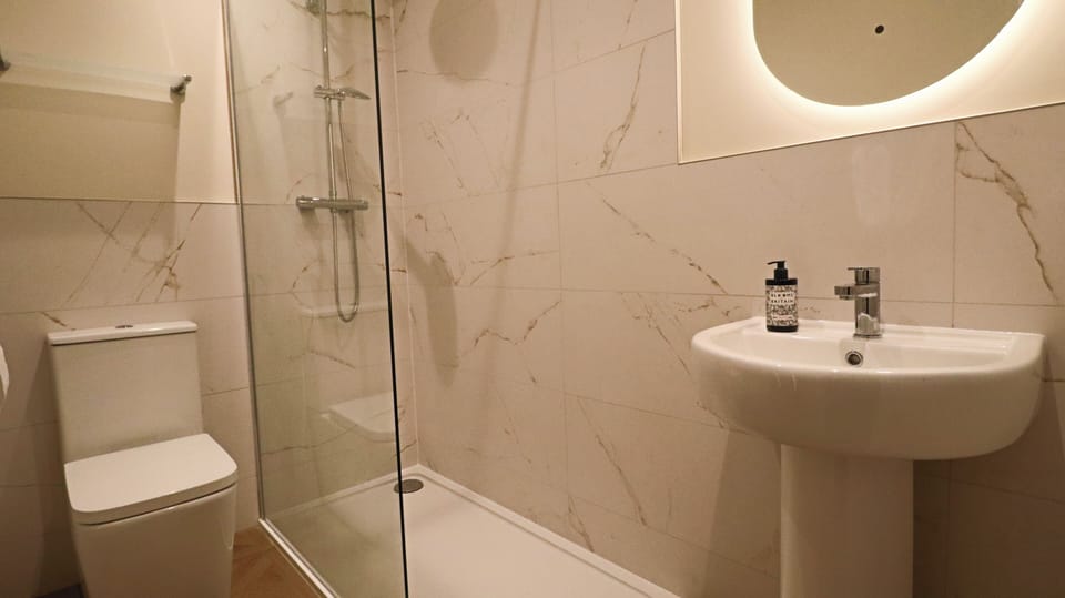 Shower, rainfall showerhead, hair dryer, towels